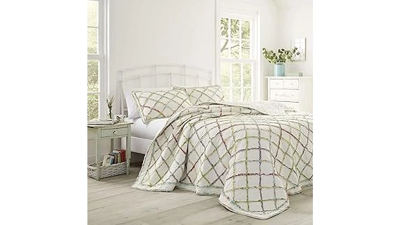 The image shows a beautiful, ruffled floral quilt ideal for a garden review.