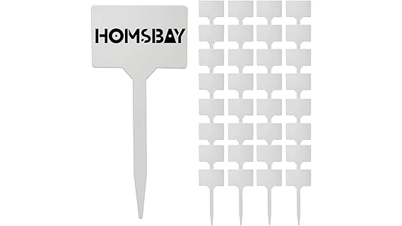 The image shows colorful plant labels inserted into a variety of vegetable garden plants.