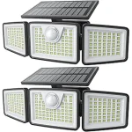 The image shows several bright solar motion sensor lights mounted on a wall in an outdoor setting.