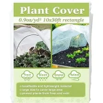 The image shows several breathable frost protection covers protecting plants from winter weather.