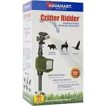 The image shows a motion activated garden sprinkler deterring a critter from a yard.