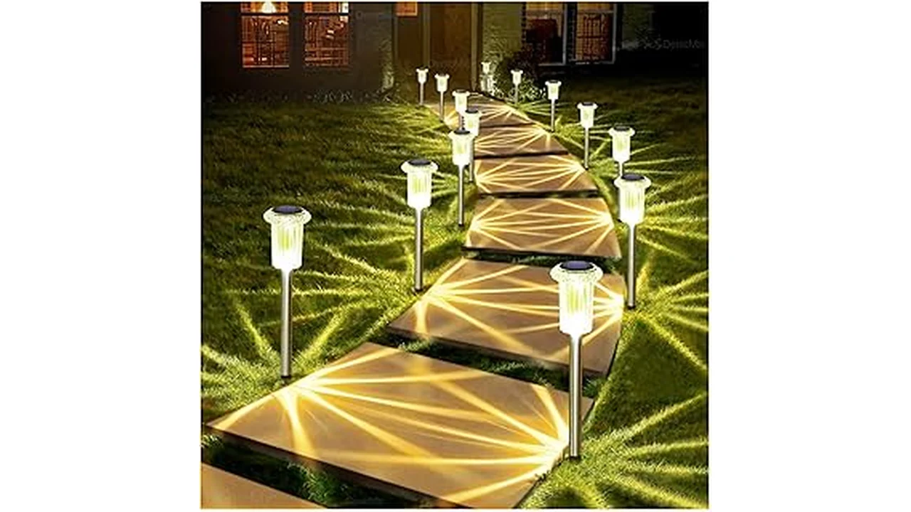 The image shows a garden stake light pack, illuminating a pathway in a beautiful outdoor setting.