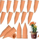 The image shows various slow-release watering stakes being used in potted plants for consistent plant hydration.