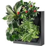 The image shows a green wall garden planter with multiple pocket slots holding various plants.
