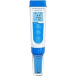 The image shows a digital pH meter being used to test the water in a hydroponic system.