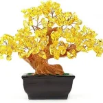 The image shows a vibrant artificial bonsai tree with yellow leaves, likely from a popular selection.