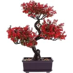 This image shows a lifelike artificial bonsai tree, highlighting its detailed foliage and decorative pot.