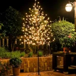 The image shows a beautifully lit artificial bonsai tree, a top-rated decorative option for your home.