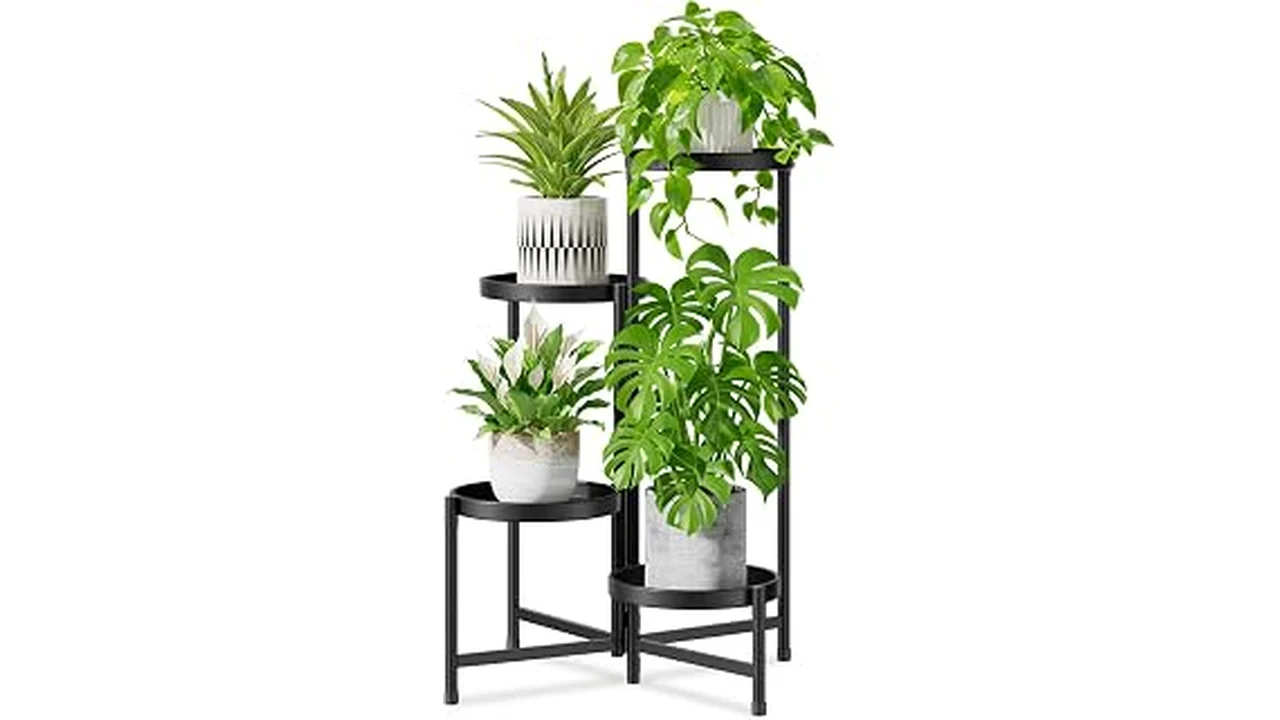 This image shows an elegant freestanding indoor plant stand holding a lush potted plant in a stylish home setting.