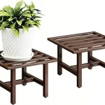 The image shows a large, heavy potted plant safely supported on a sturdy indoor plant stand, part of a review.