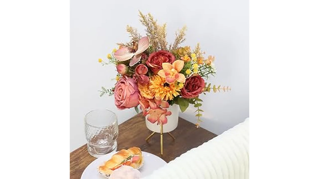 The image shows elegant artificial flowers arranged in a stylish vase, perfect for a living room review.